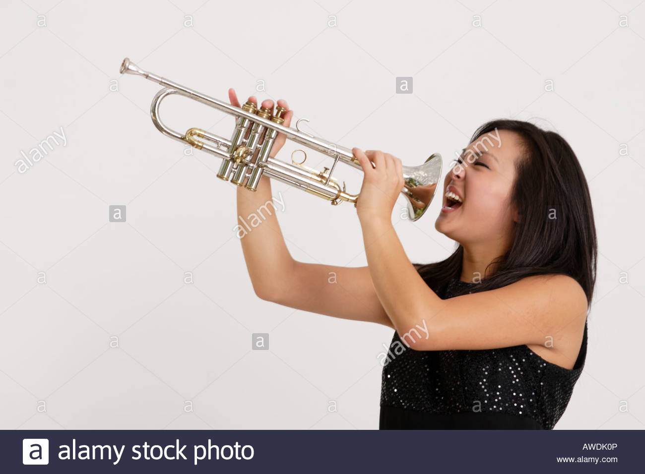 stock-photograph-of-a-pretty-asian-girl-screaming-into-a-trumpet-AWDK0P.jpg